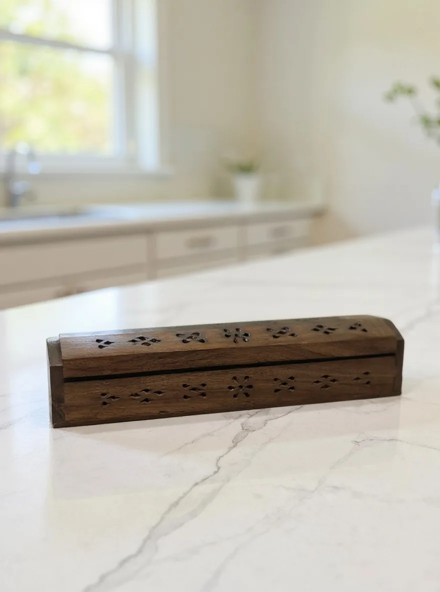 The carved incense box photographed in the Marble Counter scene
