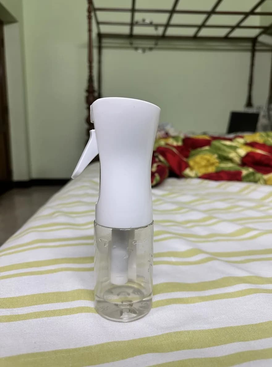 The original phone photo of the glass spray bottle